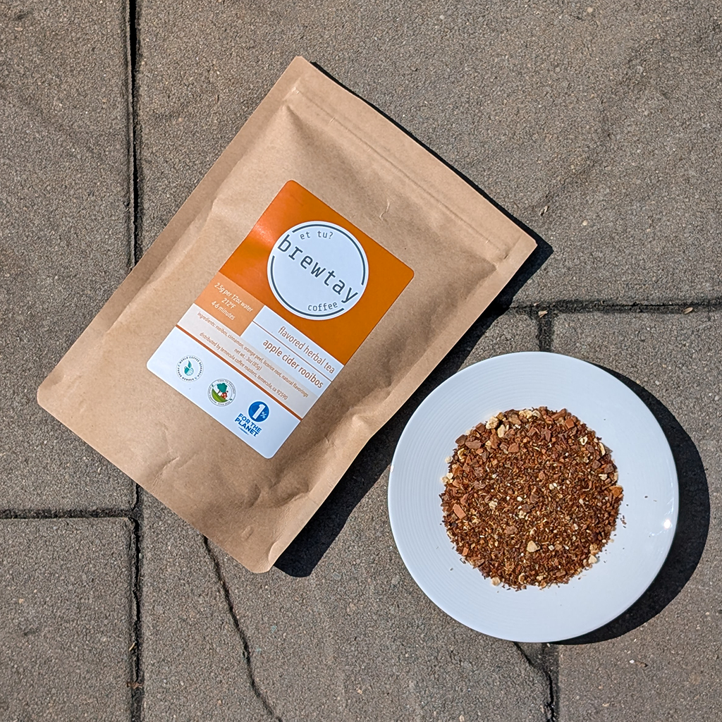 Brewtay coffee package and ground coffee on a plate on a concrete surface