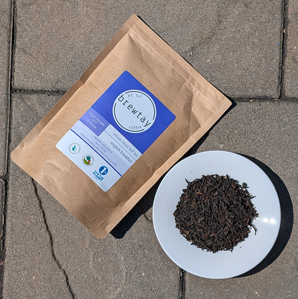 Brewtay coffee package and coffee grounds on a concrete surface