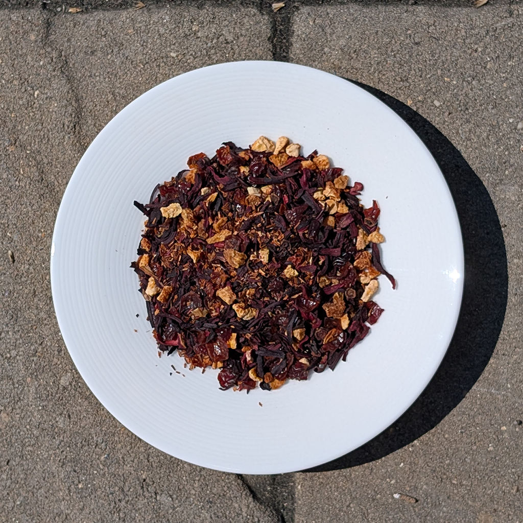 White plate with a mix of dried fruits on a concrete surface