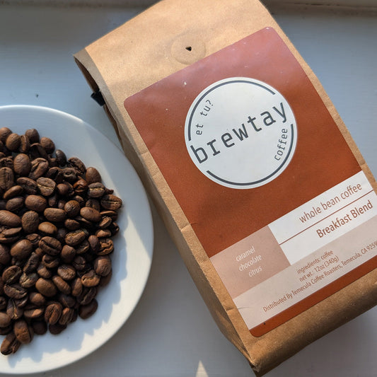 Brewtay coffee breakfast blend package with coffee beans on a white plate