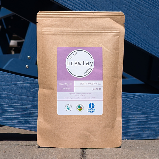 Brown paper bag with a purple label on a blue wooden background