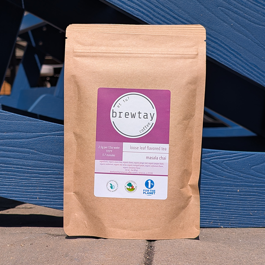 Brewtay tea package with a purple label against a blue wooden background