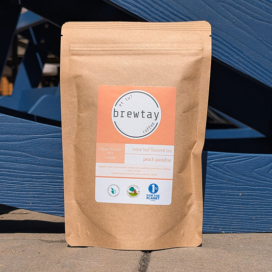 Brown paper bag with Brewtay label against a blue metal background